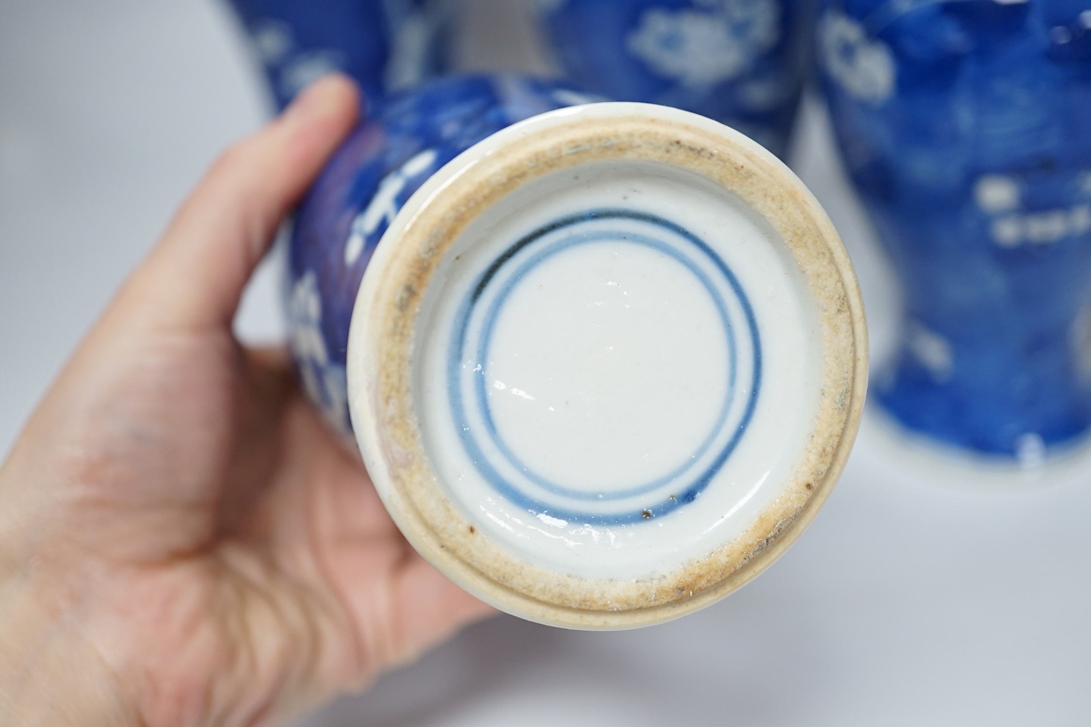 Five early 20th century Chinese blue and white prunus vases and covers, tallest 31cm